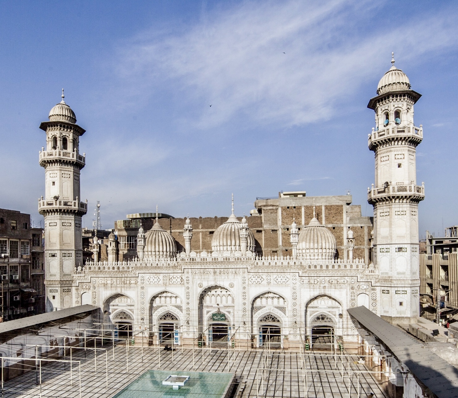 Photograph of a mosque, set against a blue sky.